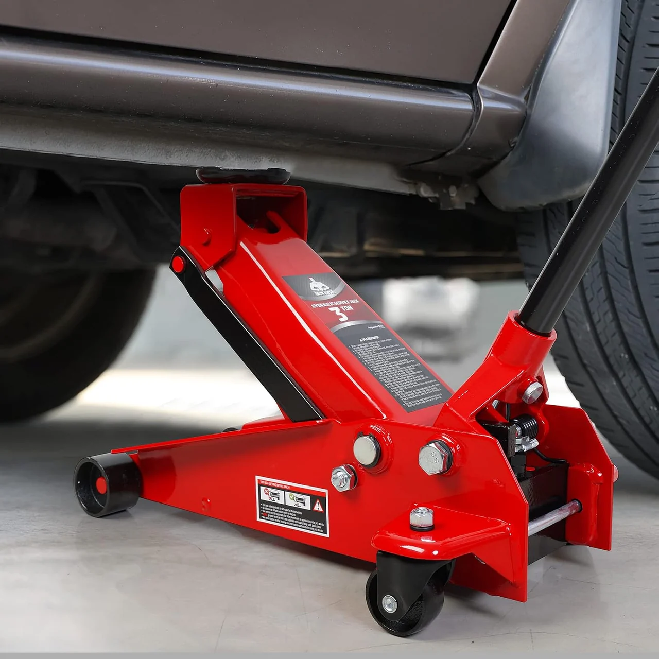 Red Jack Boss floor jack positioned at a vehicle lifting point